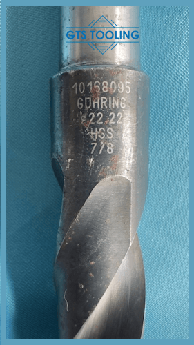 HSS twist drill 0.875 inches in diameter showing the full length with the use of a tape measure plus the manufacturer's full engraved specification