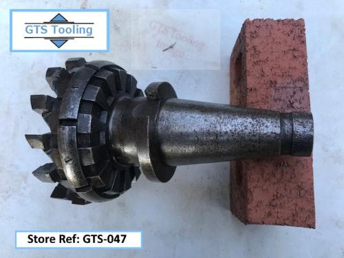 Image of a 150mm (6") Diameter, Heavy Duty Carbide Tipped Milling Cutter. With an engineers steel rule showing the precise diameter of the cutter head. The size of this milling cutter is shown in comparison to a standard brick. Priced at £75 from GTS-Tooling.co.uk.